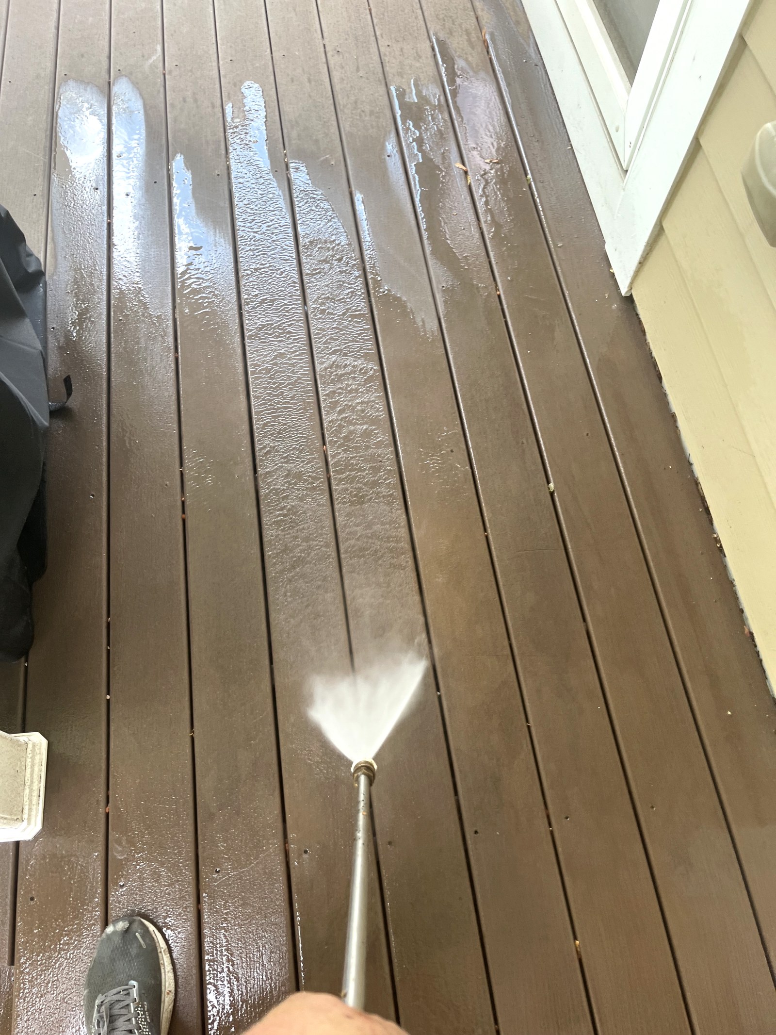 Pressure washing a deck during prep